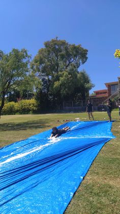 people are playing in the water on an inflatable pool