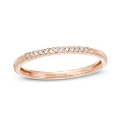 a rose gold wedding band with white diamonds