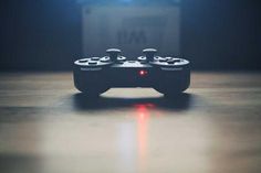 a video game controller sitting on top of a wooden table