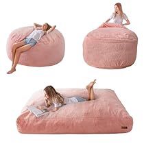 a woman laying on a pink bean bag chair