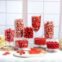 a table topped with lots of red and white candies