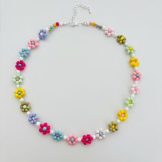 Style code: BA002 Material: Beads,Glass Bead Color: Multi colour, Colorful Weight: 16.8g/0.6oz Dimensions (Overall):  43cm/16.9inch Closure: Lobster claw Chain style: Bead Notice: Since this beaded daisy necklace  is handmade, there might be a little differences in each one, please kindly noticed Widely Application: Colorful Flower necklace handmade glass beads daisy choker kinda cute to wear on vacation to match your bathing suits or any outfit to add some summer vibe Feature: Colorful Flower n Multicolor Round Beads Flower Necklace For Summer, Handmade Flower Necklace With Round Beads For Beach, Multicolor Beaded Flower Necklace With Round Beads, Multicolor Flower Shaped Beaded Necklace With Tiny Beads, Colorful Beaded Flower Necklace For The Beach, Colorful Beads Flower Necklace For Beach, Beaded Multicolor Flower Necklace For Beach, Colorful Beaded Flower Necklace For Beach, Multicolor Flower Necklace With Colorful Beads For Festivals