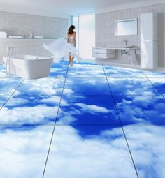 a woman in a white dress walking across a bathroom floor covered in blue and white clouds