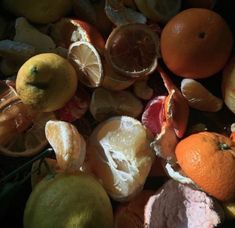 there are many different types of fruit on the table and one is oranges, lemons, and grapefruits