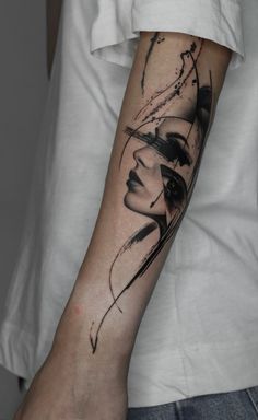 a woman's arm with a black and white tattoo design on the left forearm