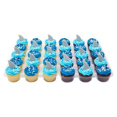 cupcakes with blue frosting and shark fin decorations