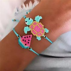 two bracelets that have different designs on each one arm and are decorated with beads