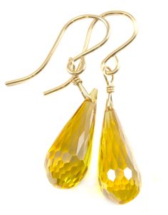 These are long teardrops of cubic zirconia in a beautiful canary yellow simulated diamond drop. The sparkle is amazing! The french earwires are 14k solid gold or 14k gold filled or sterling silver - you choose. The stone size is 7x18mm. The earrings hang 1.3 inches. This is high quality AAA CZ with beautiful faceting. There is 20 carats of CZ in a rounded briolette micro faceted teardrop cut. A great wardrobe staple. The mannequin shows the relative size and how they will hang. Shipping is Free! Diamond Cut Teardrop Earrings, Diamond Cut Teardrop Earrings Gift, Elegant Yellow Long Drop Jewelry, Yellow Briolette Earrings For Formal Occasions, Yellow Pear-shaped Gemstone Jewelry, Gold Pear-shaped Teardrop Earrings In Sterling Silver, Yellow Gold Sterling Silver Teardrop Earrings, Elegant Yellow Teardrop Dangle Earrings, Yellow Faceted Dangle Earrings