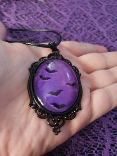 This gothic/victorian style necklace features a black frame and a purple interior. The bats appear to be flying. Perfect necklace for anyone who loves gothic jewlery! The pendant lays on a black waxed adjustable necklace cord and is 20" long. 2.48"×1.46" *size is approximate* *one sided* Gothic Purple Necklace For Halloween, Gothic Purple Jewelry For Halloween, Bat Pendant, Hex Girls, Purple Interior, Gothic Victorian, Necklace Cord, Victorian Gothic, Adjustable Necklace