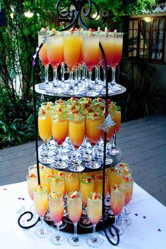 a tiered tray filled with drinks on top of a table