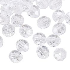 clear crystal beads are scattered on a white surface