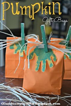 pumpkin gift bags with handprinted hands on them and the words, pumpkin gifts