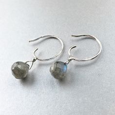 "These simple small sterling silver hoop earrings can go with any outfit. The faceted round Labradorite drops shimmer and reveals soft blue, gold, and green hues in the light. Each labradorite is about 8mm and the earrings drop length is about 1/2\" inch. An elegant design that makes the perfect gift for yourself or a loved one." Minimalist Faceted Drop Earrings, Silver Briolette Earrings For Everyday, Handmade Briolette Earrings In Minimalist Style, Everyday Faceted Labradorite Jewelry, Minimalist Sterling Silver Briolette Earrings, Dainty Sterling Silver Hoop Earrings With Gemstone, Minimalist Faceted Everyday Earrings, Handmade Labradorite Earrings For Everyday, Everyday Briolette Sterling Silver Earrings