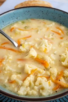 a blue bowl filled with cauliflower and carrots