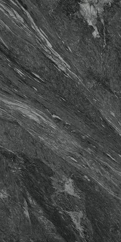 a black marble textured surface with white and gray streaks on it's edges