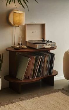 a record player sitting on top of a wooden shelf