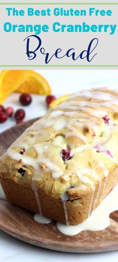 the best gluten free orange cranberry bread on a wooden plate with icing