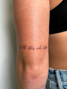 a woman with a tattoo on her arm saying it's the time to be late