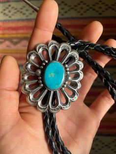 "Beautiful heavy duty Navajo sandcasted bolo tie with sterling silver accents and large turquoise stone on a 37\" long braided leather tie & sterling silver tips. Face measures 2 1/2\" long by 2\" across." Bohemian Concho Bolo Ties For Rodeo, Artisan Turquoise Bolo Ties With Concho, Southwestern Concho Bolo Tie For Ranch, Handmade Turquoise Vintage Bolo Ties, Handmade Vintage Turquoise Bolo Ties, Southwestern Bolo Ties With Concho For Ranch, Southwestern Bolo Ties With Concho, Bohemian Silver Bolo Ties For Western-themed Events, Silver Bohemian Bolo Ties For Western-themed Events