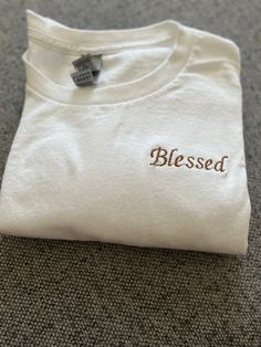 Choose any short quote and I can embroider it for you on a t-shirt! Different color letters and t-shirts available! I have any color thread and the t-shirt colors are as listed thank you :) (100% cotton) Text Embroidery Shirt, White Cotton T-shirt As Gift, Cotton T-shirt With Embroidered Text, Crew Neck, White T-shirt With Letter Embroidery For Gift, White T-shirt With Letter Embroidery As Gift, White T-shirt With Embroidered Graphics As Gift, White Cotton T-shirt With Embroidered Text, White Cotton T-shirt With Embroidered Graphics, White Embroidered T-shirt For Gift