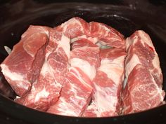 raw meat being cooked in a slow cooker