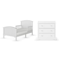 a white baby bed and dresser against a white background