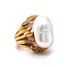 This Mid-Century inspired cocktail ring truly shines! A stunning Mabe pearl is the centerpiece of the ring, surrounded by forty (40) round brilliant cut diamonds. The diamonds measure 1.6 mm and weigh .018 carats each. This ring is sure to make a statement, whether you wear it for a night out or save it as a special heirloom. A timeless addition to any jewelry collection. Luxury Pearl Ring With Rose Cut Diamonds For Anniversary, Luxury Pearl Ring For Evening, Luxury Oval Pearl Ring, Luxury Pearl Rings With Diamond Accents, Luxury Yellow Gold Pearl Ring With Rose Cut Diamonds, Diamond Cocktail Ring, Mabe Pearl, Diamond Cocktail Rings, Pearl Diamond