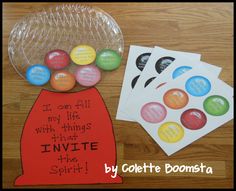 some paper and buttons are on the table next to a plastic bag with stickers