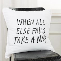 a pillow that says when all else falls take a nap on top of a chair