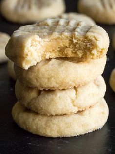 a stack of cookies sitting on top of a black table next to other cookies in the background