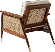 a wooden chair with wicker back and arm rests against a white background in the foreground