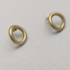 Olly earrings - these simple but stylish stud earrings are crafted from brass and coated with a matte gold plating for a timeless look. Perfect for any occasion, these earrings are a must-have for any luxury jewelry collection. Simple stud earrings, crafted from brass with a matte gold plating. Weight: 7.9 gm Dimensions: 1.9 cm x 1.9 cm Classic Matte Finish Jewelry Gift, Formal Minimalist Brass Hoop Earrings, Minimalist Matte Finish Jewelry Gift, Minimalist Gold-plated Circle Earrings, Minimalist Gold Plated Circle Earrings, Minimalist Gold Jewelry With Matte Finish, Modern Gold Jewelry With Matte Finish, Minimalist Matte Gold Jewelry, Minimalist Matte Finish Gold Jewelry