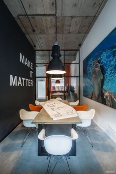 an instagramted photo of a dining room table with chairs and artwork on the wall