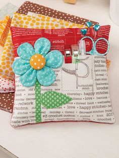 three small purses are sitting on a table with scissors and other items in them