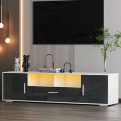 an entertainment center in a living room with a television mounted on the wall above it