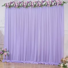 a purple backdrop with white and pink flowers