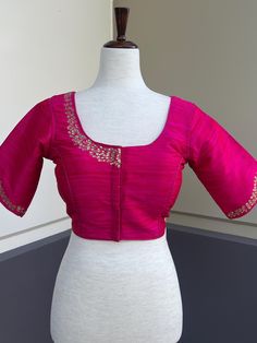 Hot Pink Color with slight tint of orange Raw Silk Readymade Blouse with beautiful Stone Handwork. Item : Readymade Blouse Ready-to-Wear : Yes Size : 36 (Can be opened to Size 40) Color : Hot Pink with a slight tint of Orange  Blouse Fabric : Soft Silk  Lining : Yes, it is fully lined  Padded or Non-Padded : Padded Closure: Front Closure with hooks. Disclaimer - :  -This is a Standard Size blouse. We do not guarantee perfect fit as every body and shape is different. Little or no alteration would Wedding Tops With Short Sleeves And Self Design, Fitted Bollywood Blouse Piece For Spring, Festive Short Sleeve Padded Blouse, Fitted Short Sleeve Blouse With Zari Work, Elegant Short Sleeve Top With Resham Embroidery, Fitted Short Sleeve Tops With Zari Work, Elegant Summer Blouse With Self Design, Elegant Self Design Summer Blouse, Fitted Pink Blouse For Festive Occasions