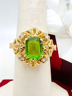 14K Yellow Gold Synthetic Emerald & Diamond 0.20ct Ring Size 6.15 approximately A perfect gift for your loved one for any special occasion or holiday! Total Ring Weight: 6.00g Ring Length: 26.28mm Ring Width: 21.92mm Gemstone: Synthetic Emerald, Diamond Total Diamond: 0.20ct Item will be placed into a gift box.  * Emerald Ring With Diamond Cut As A Gift, Green Diamond Ring As A Gift, Green Ring With Diamond Accents Gift, Green Rings With Diamond Accents As A Gift, Diamond Ring For May Birthstone As A Gift, Formal Green Birthstone Ring With Diamond Accents, May Birthstone Diamond Ring, Diamond Cut For Gift, Luxury Diamond Ring For May Birthstone As A Gift, May Birthstone Ring With Diamond Accents As A Gift