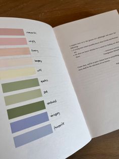 an open book with different shades of paint on the pages and in it's center