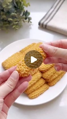 two hands reaching for waffles on a plate