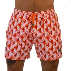 Step back in time to the 70s with East x East Island Fever men's shorts. Featuring a bold orange colorway and a retro-inspired design, these shorts are the perfect addition to any fashion-forward individual's summer wardrobe. Made with premium sustainable materials, these shorts not only look great but are eco-friendly too. The elasticated waist and drawstring adjustment ensure a comfortable and secure fit, making them perfect for any summer activity, from beach days to pool parties. With their Orange Short Swim Trunks With Built-in Shorts, Orange Swim Trunks With Built-in Shorts, Orange Short Swim Trunks For Beachwear, Orange Summer Swim Trunks, Orange Beachwear Shorts, Orange Beachwear Shorts For Summer, Retro Red Beach Shorts, Orange Swim Trunks With Built-in Shorts For Summer, Orange Beachwear Shorts For Spring