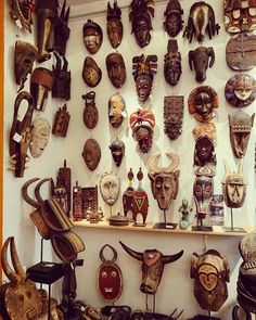 an assortment of masks on display in a shop