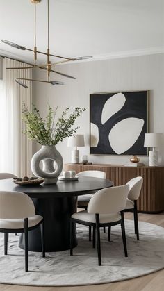 a dining room table surrounded by white chairs