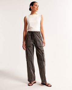 High rise pants in a soft cotton-blend fabric and wide-leg silhouette, featuring a pull-on style elasticated waistband with functional drawcords for comfort and adjustability, cargo-inspired details, zipper detail at cuffs and pockets throughout. Linen Dress Pants, Female Features, Wide Leg Cargo Pants, Lace Pants, Leather Pant, Women's Bottoms, Grey Material, Women Cargos, Cargo Pants Women