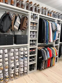 a large closet filled with lots of shoes and handbags on top of shelves next to each other