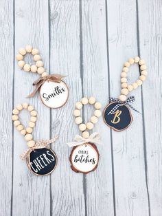 three wooden beaded necklaces with name tags on them, one is for boys and the other is for girls