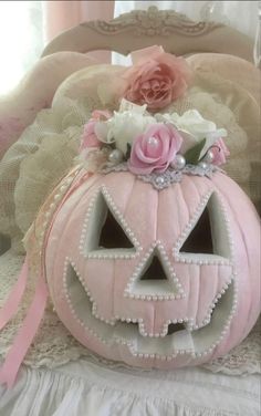 a pink pumpkin decorated with flowers and pearls