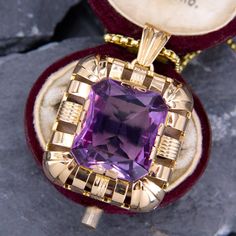 This fabulous large amethyst pendant is centered with a rectangular cut amethyst that is accented with a halo of high polished open gold work. The pendant is crafted in 14k yellow gold and is about 1.25" long. We have added an 18 inch long 14k yellow gold rounded box chain weighing approximately 3 grams. Art Deco Gold Jewelry With Rectangular Stone, Luxury Purple Jewelry For Collectors, Octagon Shaped Yellow Gold Amethyst Jewelry, Classic Purple Jewelry With Rectangular Stone, Elegant Purple Jewelry With Large Pendant, Art Deco Amethyst Jewelry Gift, Purple Amethyst Art Deco Jewelry, Classic Purple Pendant Jewelry, Art Deco 14k Gold Rectangular Jewelry