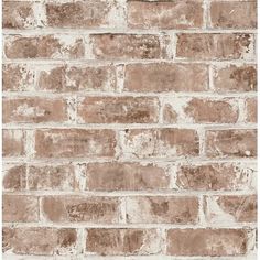 an old brick wall that is brown and white