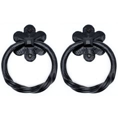 two black metal rings with flowers on each end and one has an attached cord to it